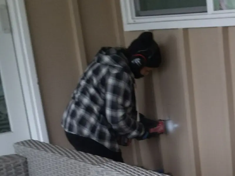 Professional electrician installing an exterior outlet in Hampstead